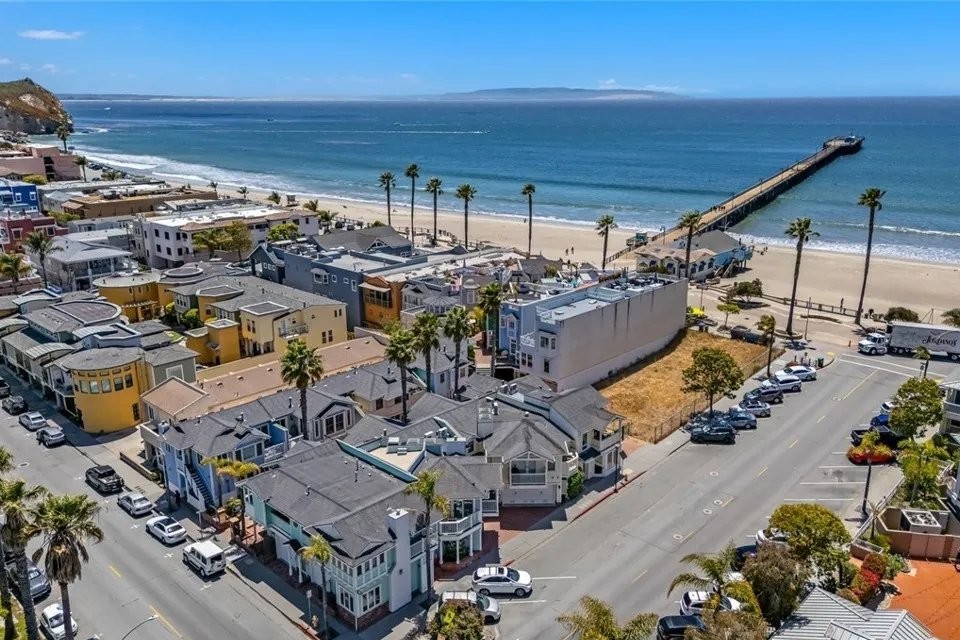 Aerial view of downtown Avila Beach homes, the beach, and the pier