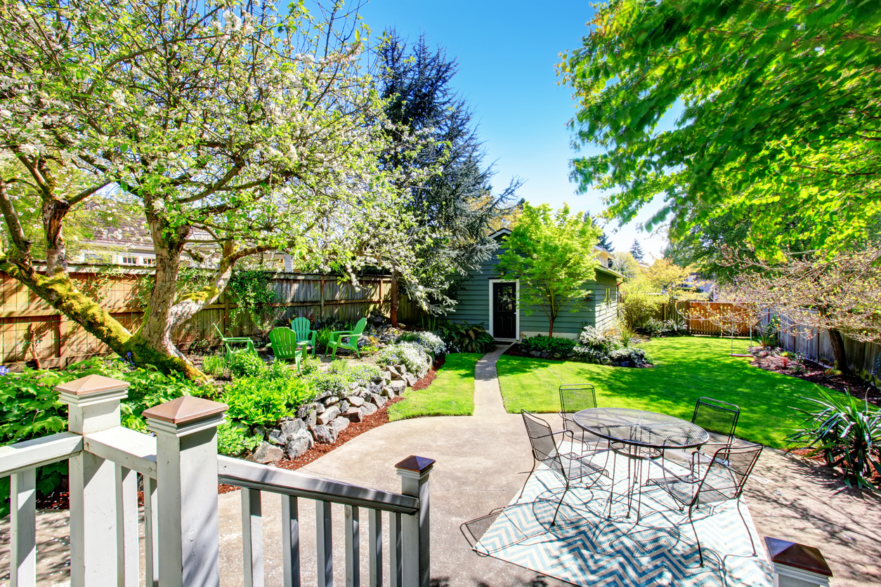 Detached backyard guest unit with patio and lawn, shown as an example of an unpermitted ADU