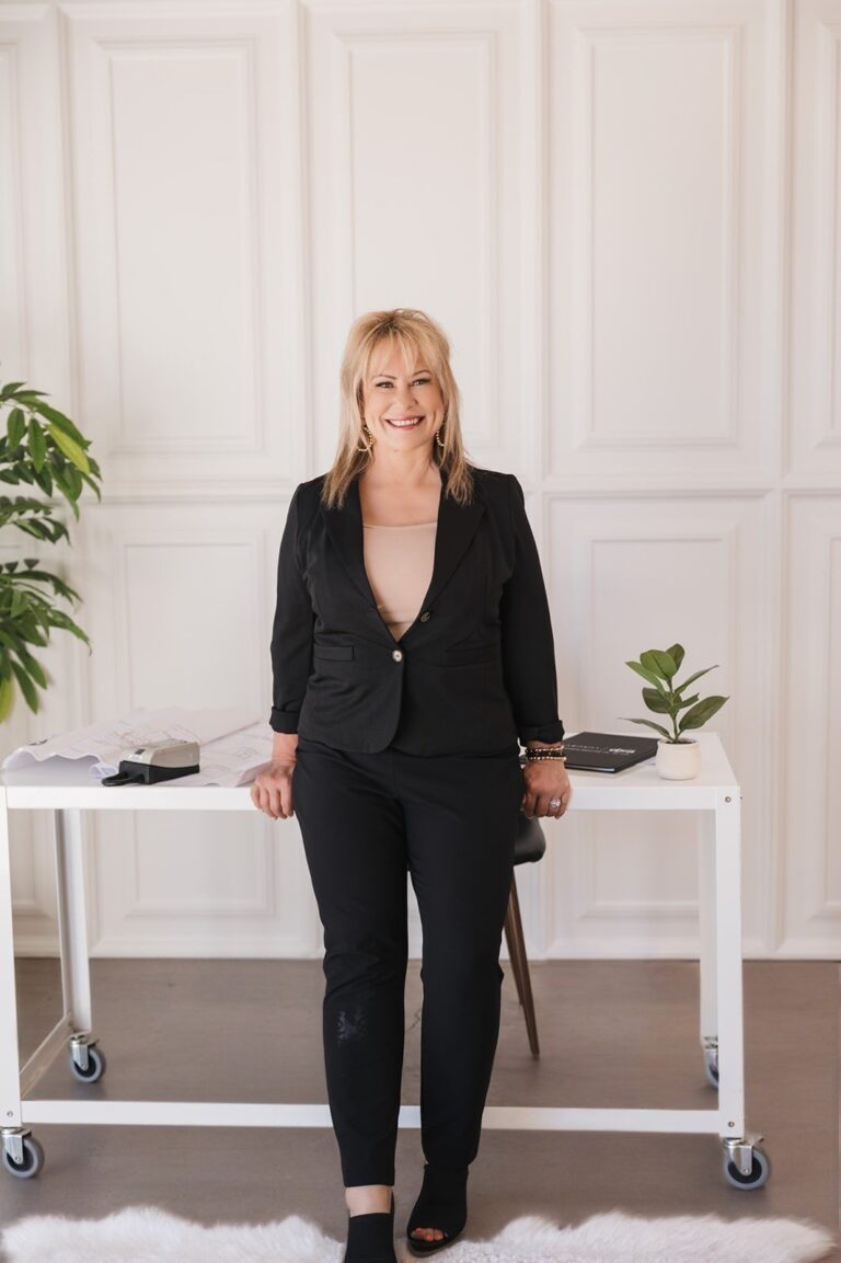 Wina Gill Realtor standing in front of her desk in San Luis Obispo ca